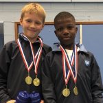 2 boys wearing medals