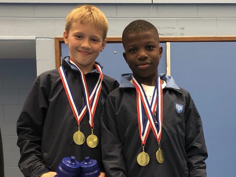 2 boys wearing medals